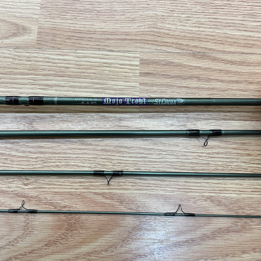 St. Croix Mojo Trout 8' 4wt fly rod in four pieces showing on a wooden background