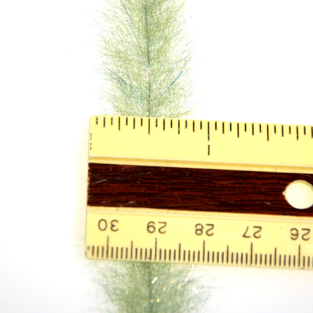 Sculpting Flash Brush in Olive Color for fly tying on a white background with a ruler for size reference